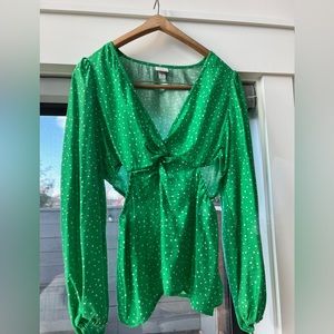 Bright and fun green polka dot top with puff sleeves and side cutouts